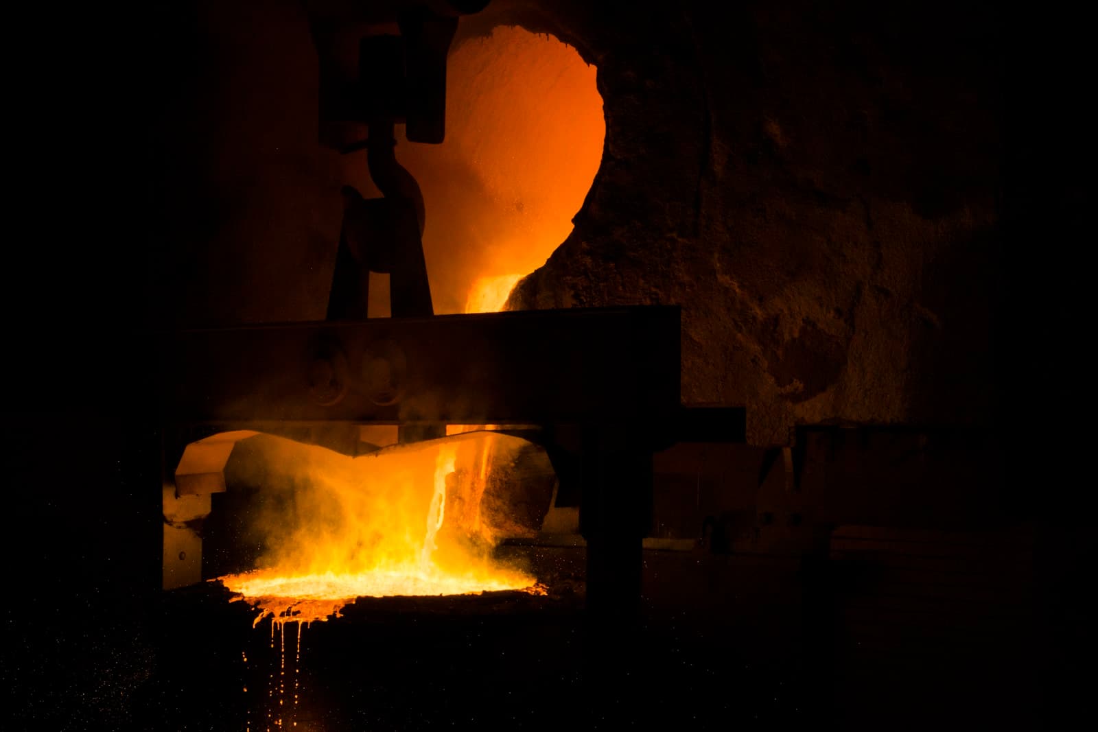 An operator standing in front of a metal furnace