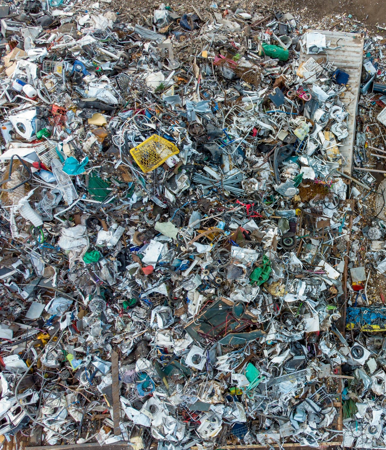 A pile of metal scrap beside a building